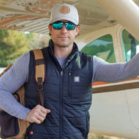 Man wearing Flight Outfitters Insulated Airfoil Vest in front of Cessna 172