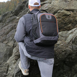 Man hiking up rocks wearing Flight Outfitters Aviator Backpack