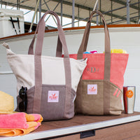 Flight Outfitters Tote Bags in Grey and Orange on a dock