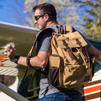 A man carrying the Flight Outfitters Bush Pilot Rucksack on his back, demonstrating its ergonomic fit.