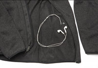 Interior pocket of the Women's Fairbanks Fleece in Heather Obsidian, designed for hands-free phone storage with a headphone cable port.