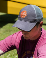 A man wearing the Flight Outfitters Grey Trucker Hat, demonstrating its comfortable fit and aviation-inspired style.