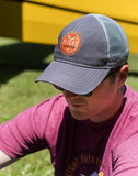 A man wearing the Flight Outfitters Grey Trucker Hat, demonstrating its comfortable fit and aviation-inspired style.