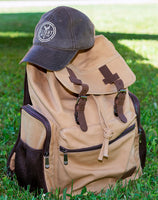 A Flight Outfitters hat placed on the Bush Pilot Rucksack, emphasizing complementary gear.