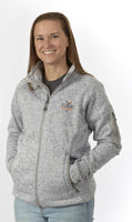  A woman standing while wearing the Women's Fairbanks Fleece in Heather Stone, displaying its tailored design.