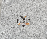 Close-up of the Flight Outfitters logo on the Fairbanks Fleece, emphasizing its premium quality branding.