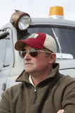 A man wearing the Flight Outfitters Seaplane Hat, highlighting its lightweight fabric and stylish design.